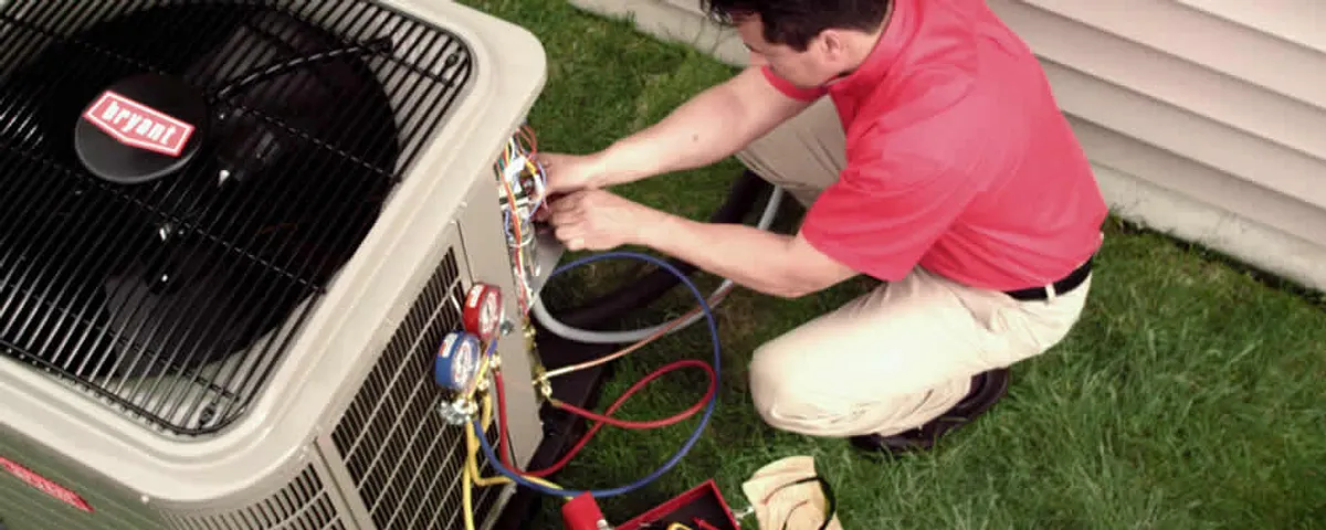HVAC technician servicing an outdoor air conditioner unit in San Antonio, TX