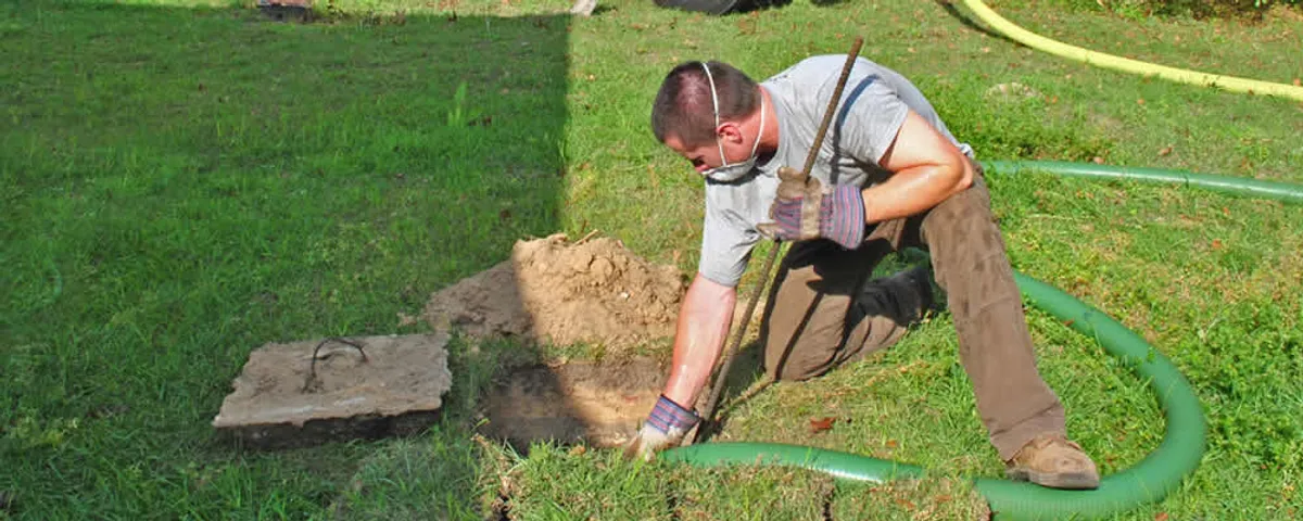 Septic pumping technician servicing a residential septic tank in San Antonio, TX